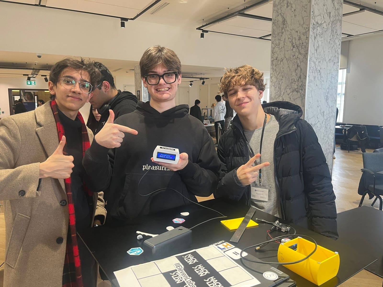 The three ClearZone founders at the hackathon, holding the first working proof of concept