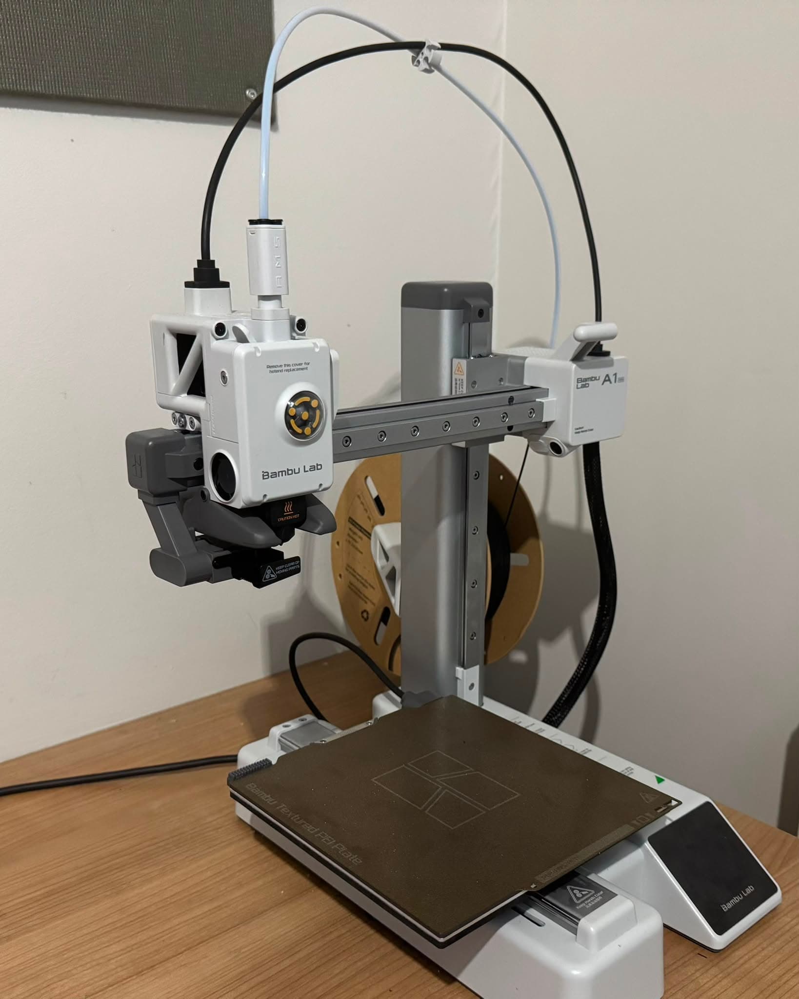 A Bambu Lab A1 mini 3D printer on the ClearZone workbench, used alongside the P1S for in-house printing
